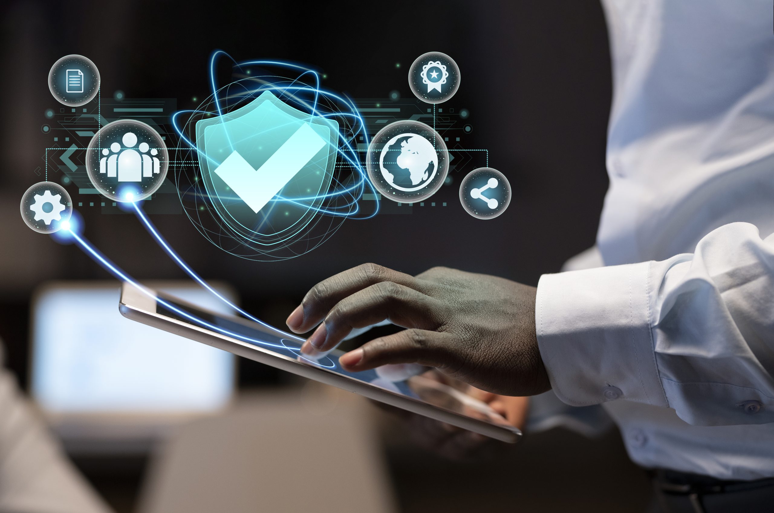 Person using a digital tablet with futuristic holographic icons representing cybersecurity, data sharing, global connectivity, and quality control.