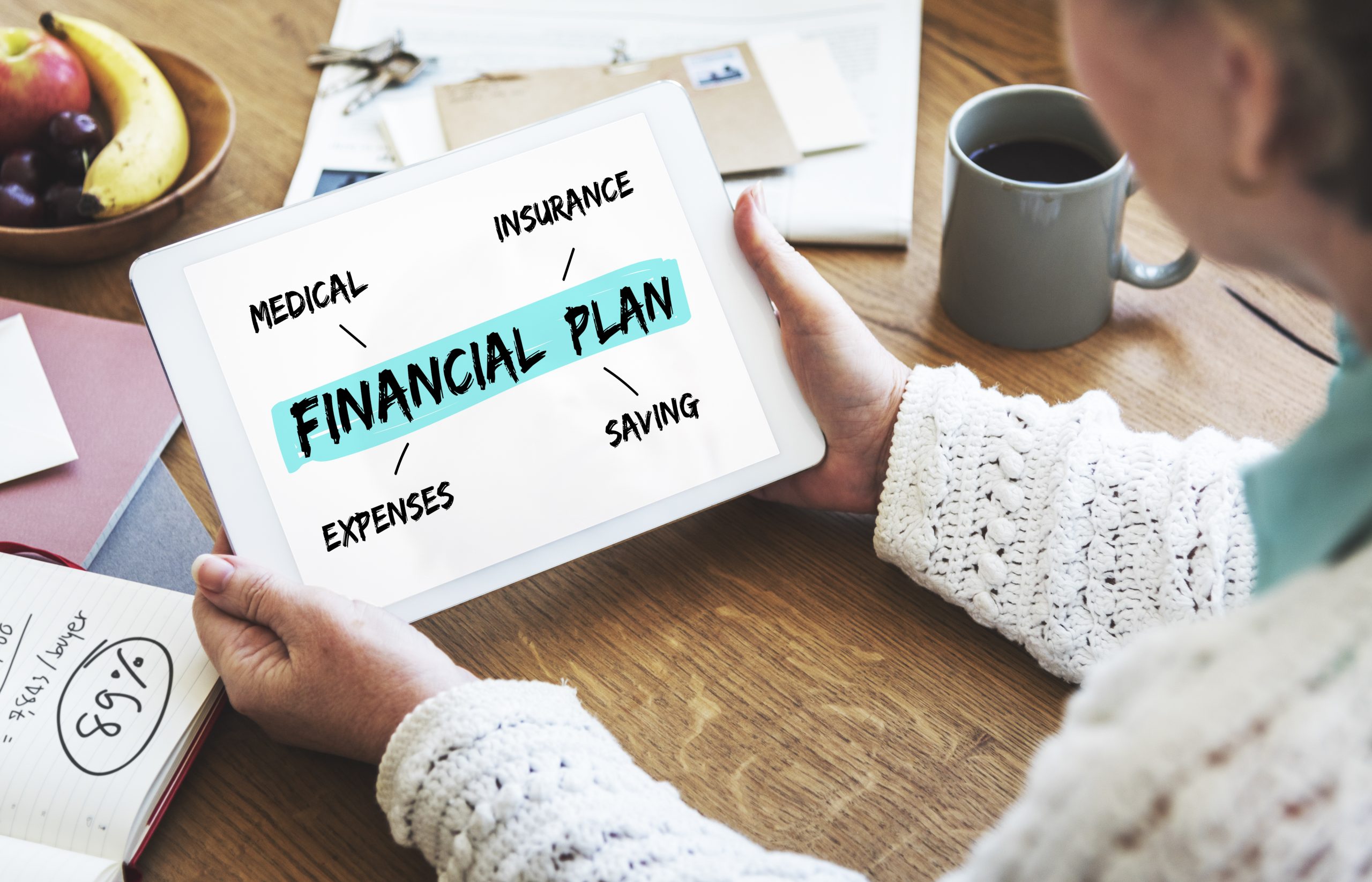 A person holding a tablet displaying a financial planning diagram with key elements like medical, insurance, expenses, and saving, symbolizing organized personal finance management.