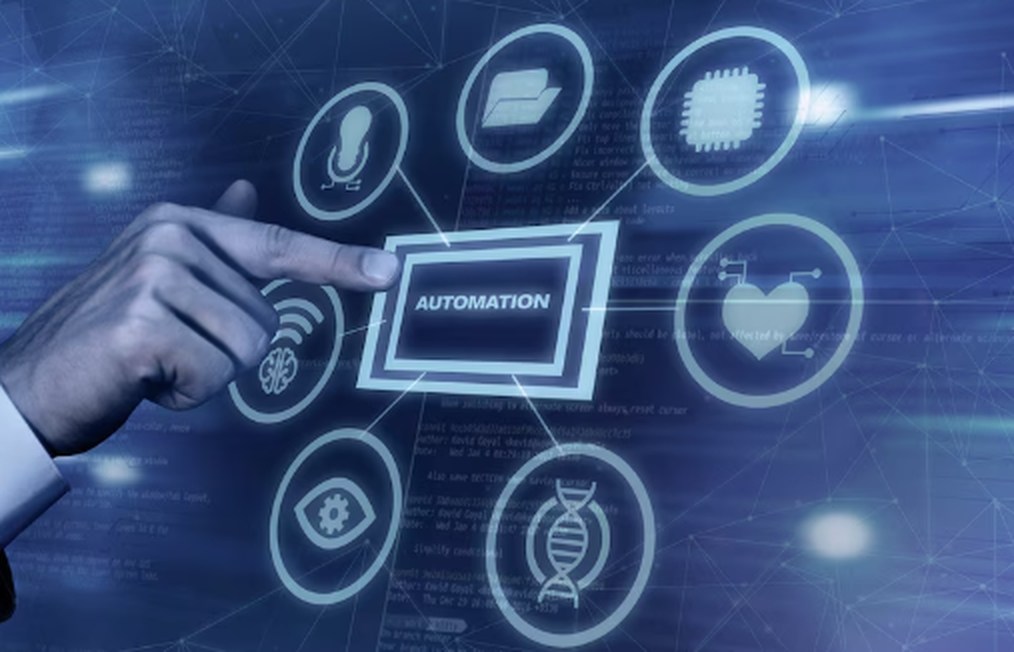 A digital interface shows a hand interacting with a futuristic touchscreen labeled "Automation," surrounded by icons representing technology, data, healthcare, AI, and machinery, symbolizing the integration of Robotics and Automation across various industries.