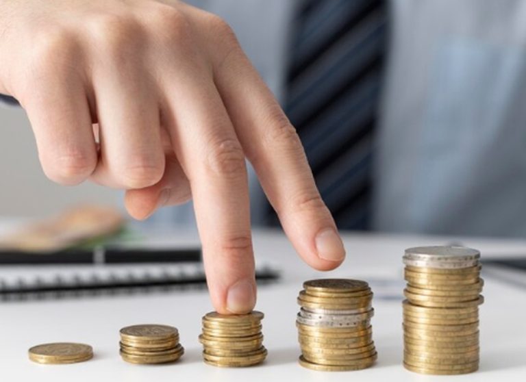 A businessperson stacking coins in ascending order, symbolizing financial growth and investment strategies related to private equity.