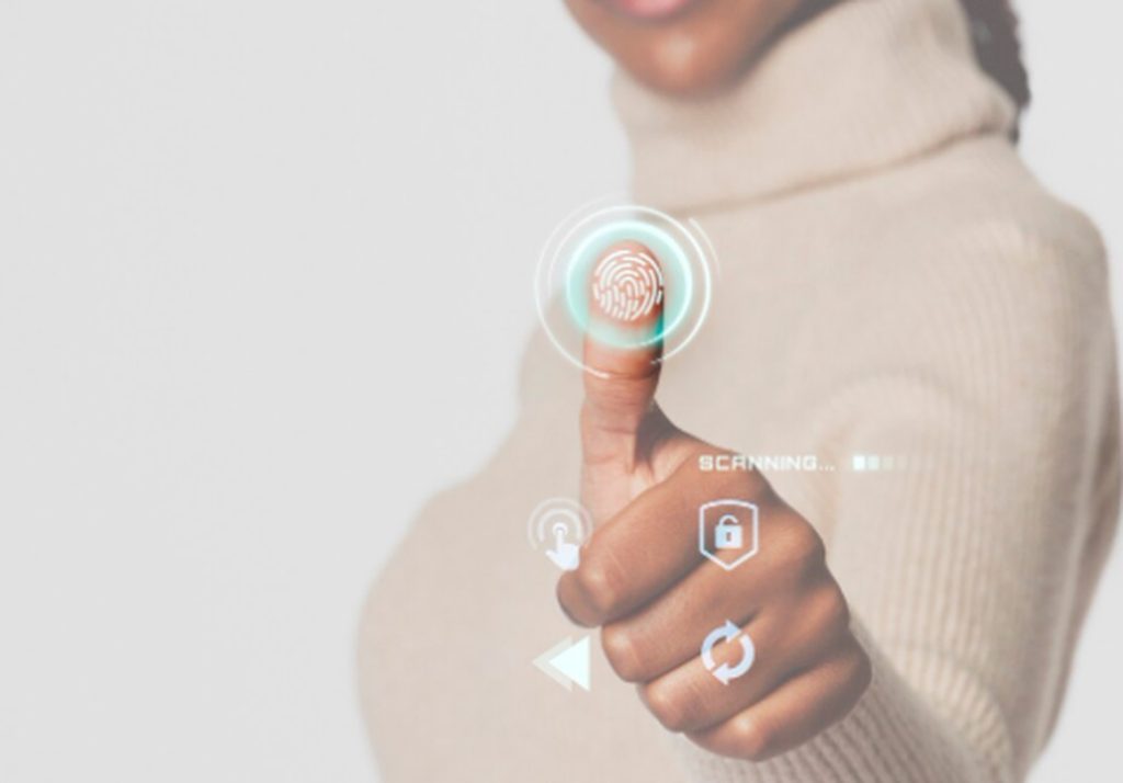 A person scanning their thumb with biometric technology, illustrating secure and modern identification for digital transactions.