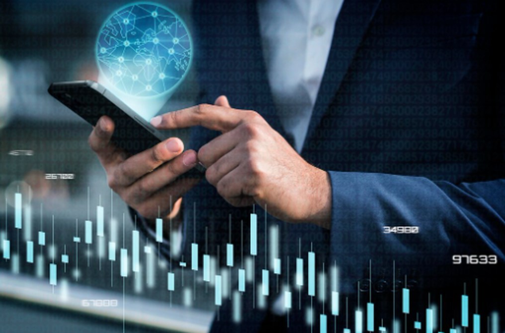 Business professional using a smartphone to analyze financial charts and data, symbolizing modern strategies for investing in Artificial Intelligence in the global market.