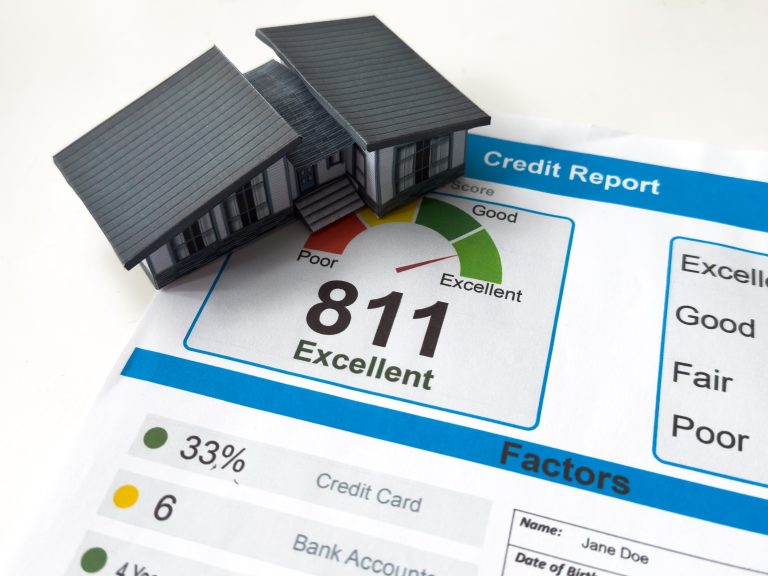 credit report showing an 811 excellent score beside a house model, illustrating what is a good credit score to buy a house.